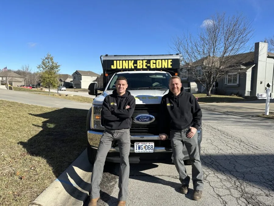 Junk Be Gone Pros posing with a junk truck