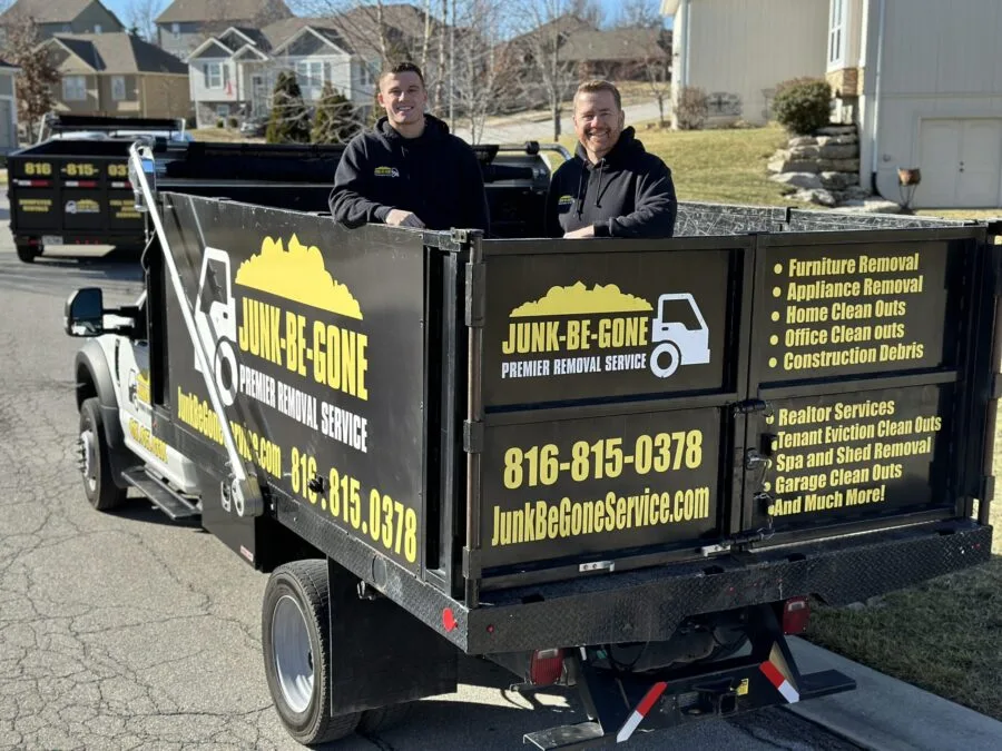 Junk Be Gone experts posing in a junk truck before performing junk removal services in Shawnee, KS
